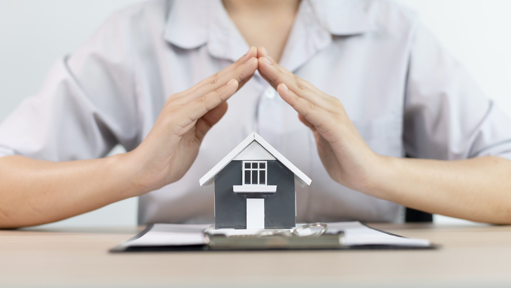 Real Estate Agent with a House Model